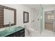 Modern bathroom with unique glass bowl sink, tile shower, and decorative mirrors at 386 Club Manor Dr, Sun City Center, FL 33573