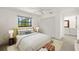 Bedroom with a large window, closet, and access to an en-suite bathroom at 386 Club Manor Dr, Sun City Center, FL 33573