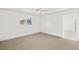 Bright bedroom features neutral carpet and a doorway to an adjacent room at 386 Club Manor Dr, Sun City Center, FL 33573