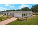 Charming single-story home with well-maintained landscaping and a brick driveway at 386 Club Manor Dr, Sun City Center, FL 33573