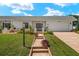 Charming single-story home featuring a well-manicured lawn and brick accents at 386 Club Manor Dr, Sun City Center, FL 33573