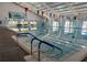 Bright indoor swimming pool area with natural light and clear water at 386 Club Manor Dr, Sun City Center, FL 33573
