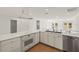 Bright kitchen featuring white cabinets, stainless steel appliances, and a range hood at 386 Club Manor Dr, Sun City Center, FL 33573
