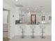 Kitchen with breakfast bar, white cabinetry, and stainless steel appliances at 386 Club Manor Dr, Sun City Center, FL 33573
