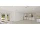 Open concept living area with kitchen visible, and French doors to the outside at 386 Club Manor Dr, Sun City Center, FL 33573