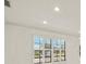Bright room featuring white walls, shuttered windows, and recessed lighting at 386 Club Manor Dr, Sun City Center, FL 33573