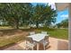 Outdoor patio with a four-chair dining set and beautiful views of the surrounding greenery at 386 Club Manor Dr, Sun City Center, FL 33573