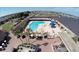 Aerial view of the community pool, hot tub, and outdoor recreation area, perfect for relaxing and entertaining guests at 386 Club Manor Dr, Sun City Center, FL 33573