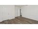 Bedroom with wood-look flooring, fresh paint and entry door, offers a blank canvas for new owners at 4005 Willow Branch Pl, Palmetto, FL 34221