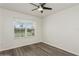 Clean bedroom with ceiling fan and neutral tones with a view of the front yard at 4005 Willow Branch Pl, Palmetto, FL 34221