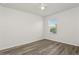 Bright bedroom with wood-look flooring, neutral paint, and natural light offers a comfortable retreat at 4005 Willow Branch Pl, Palmetto, FL 34221