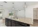 Kitchen island featuring dark cabinetry, granite countertops, and stainless steel appliances at 4005 Willow Branch Pl, Palmetto, FL 34221