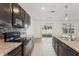 Modern kitchen featuring stainless steel appliances and a view to the fenced backyard at 4005 Willow Branch Pl, Palmetto, FL 34221
