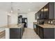 Open kitchen featuring dark cabinetry, granite countertops, and stainless steel appliances at 4005 Willow Branch Pl, Palmetto, FL 34221