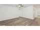 Bright living room boasts stylish shiplap wall, ceiling fan and modern wood flooring at 4005 Willow Branch Pl, Palmetto, FL 34221