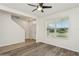 Bright living room with wood-look flooring and a large window that floods the space with natural light at 4005 Willow Branch Pl, Palmetto, FL 34221