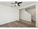 Inviting living room featuring attractive wood-look flooring, a modern ceiling fan, and stylish wall accents at 4005 Willow Branch Pl, Palmetto, FL 34221