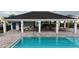 Community pool view, showcasing a covered seating area and clean, refreshing water at 4005 Willow Branch Pl, Palmetto, FL 34221