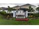 Stone and stucco community sign surrounded by flowering plants and manicured landscaping at 4005 Willow Branch Pl, Palmetto, FL 34221