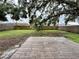 Wide backyard featuring green grass, a wooden fence, and a large tree with Spanish moss at 4110 Longhorn Dr, Sarasota, FL 34233