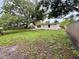 Generous backyard showcasing a well-sized lawn with a view of the home's exterior and fenced perimeter at 4110 Longhorn Dr, Sarasota, FL 34233