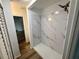 Modern shower with stylish marble-look tile and sleek fixtures at 4110 Longhorn Dr, Sarasota, FL 34233