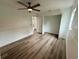 Bedroom featuring wood-look floors, ceiling fan and open closet at 4110 Longhorn Dr, Sarasota, FL 34233