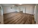 Spacious bedroom featuring modern wood-look floors, a ceiling fan, and ample natural light at 4110 Longhorn Dr, Sarasota, FL 34233