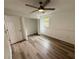 Bedroom with wood-look floors, ceiling fan and double closets at 4110 Longhorn Dr, Sarasota, FL 34233