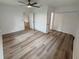 Bright bedroom with wood-look floors, a ceiling fan, and closet space at 4110 Longhorn Dr, Sarasota, FL 34233