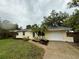 This cozy home boasts lush landscaping, a vibrant green lawn, and a meticulously mulched garden at 4110 Longhorn Dr, Sarasota, FL 34233