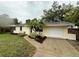 Well-maintained single-story home featuring a manicured lawn and mature landscaping at 4110 Longhorn Dr, Sarasota, FL 34233