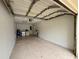 Open garage showing expansive space and potential storage or parking area with white walls at 4110 Longhorn Dr, Sarasota, FL 34233