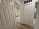 Hallway leading to other rooms, featuring wood-look floors and ample closet space at 4110 Longhorn Dr, Sarasota, FL 34233