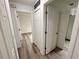 Bright hallway with neutral paint, wood-look floors, and several doorways to other rooms in the home at 4110 Longhorn Dr, Sarasota, FL 34233