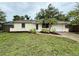 Charming one-story home with fresh mulch and landscaping and a well-maintained front lawn at 4110 Longhorn Dr, Sarasota, FL 34233