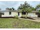 Charming one-story home with fresh mulch and landscaping and a well-maintained front lawn at 4110 Longhorn Dr, Sarasota, FL 34233