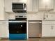 Modern kitchen appliances including an oven, microwave, range hood, and dishwasher at 4110 Longhorn Dr, Sarasota, FL 34233