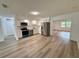 Updated kitchen with stainless steel appliances and white cabinets, open to dining area at 4110 Longhorn Dr, Sarasota, FL 34233