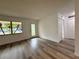 Living room featuring wood-look floors, a large window, and a glass front door at 4110 Longhorn Dr, Sarasota, FL 34233