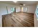 Expansive living area featuring new wood-look flooring and multiple access points to other rooms at 4110 Longhorn Dr, Sarasota, FL 34233