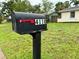Street-side mailbox with visible house number, set against a green lawn and neighborhood backdrop at 4110 Longhorn Dr, Sarasota, FL 34233