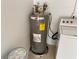 A utility room housing a water heater and a washing machine setup; functional laundry space at 4110 Longhorn Dr, Sarasota, FL 34233