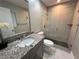 Modern bathroom with granite countertop vanity and glass-enclosed walk-in shower at 4441 Groveland Ave, Sarasota, FL 34231