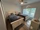 Bright bedroom featuring two beds, a ceiling fan and natural light at 4441 Groveland Ave, Sarasota, FL 34231