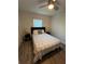 Comfortable bedroom featuring a ceiling fan and laminate wood flooring at 4441 Groveland Ave, Sarasota, FL 34231