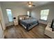 Inviting bedroom with laminate floors, natural light, and neutral decor at 4441 Groveland Ave, Sarasota, FL 34231