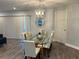 Bright dining room featuring a glass table, modern lighting, and views of the home at 4441 Groveland Ave, Sarasota, FL 34231
