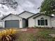 Charming single-story home features a well-maintained yard and two-car garage at 4441 Groveland Ave, Sarasota, FL 34231