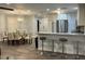 Open-concept kitchen with stainless steel appliances and breakfast bar connected to dining area at 4441 Groveland Ave, Sarasota, FL 34231